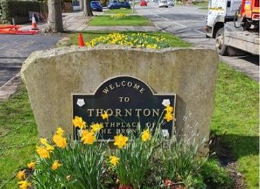 Welcome to Thornton sign surrounded by flowers