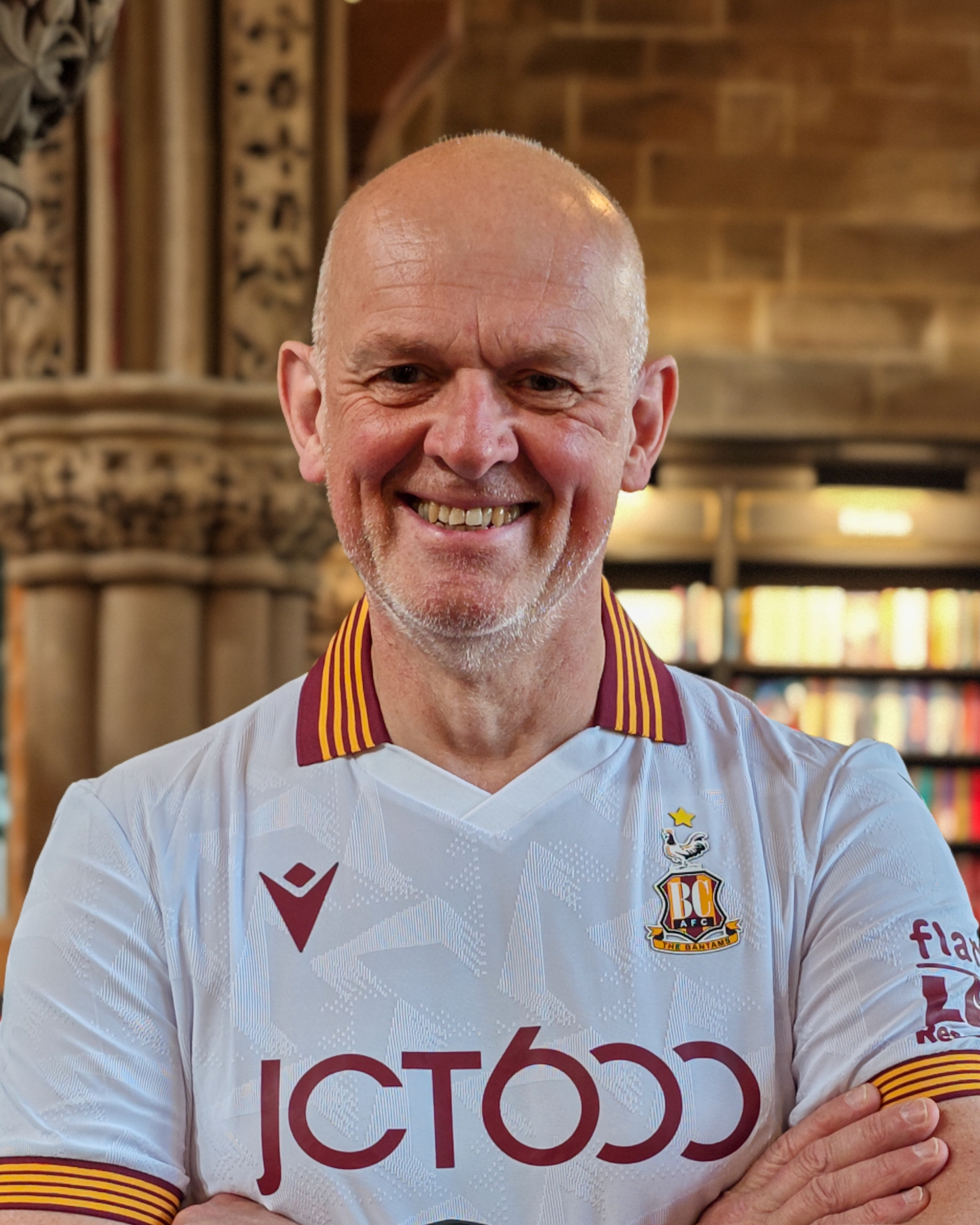 Image of a man smiling with a football t-shirt