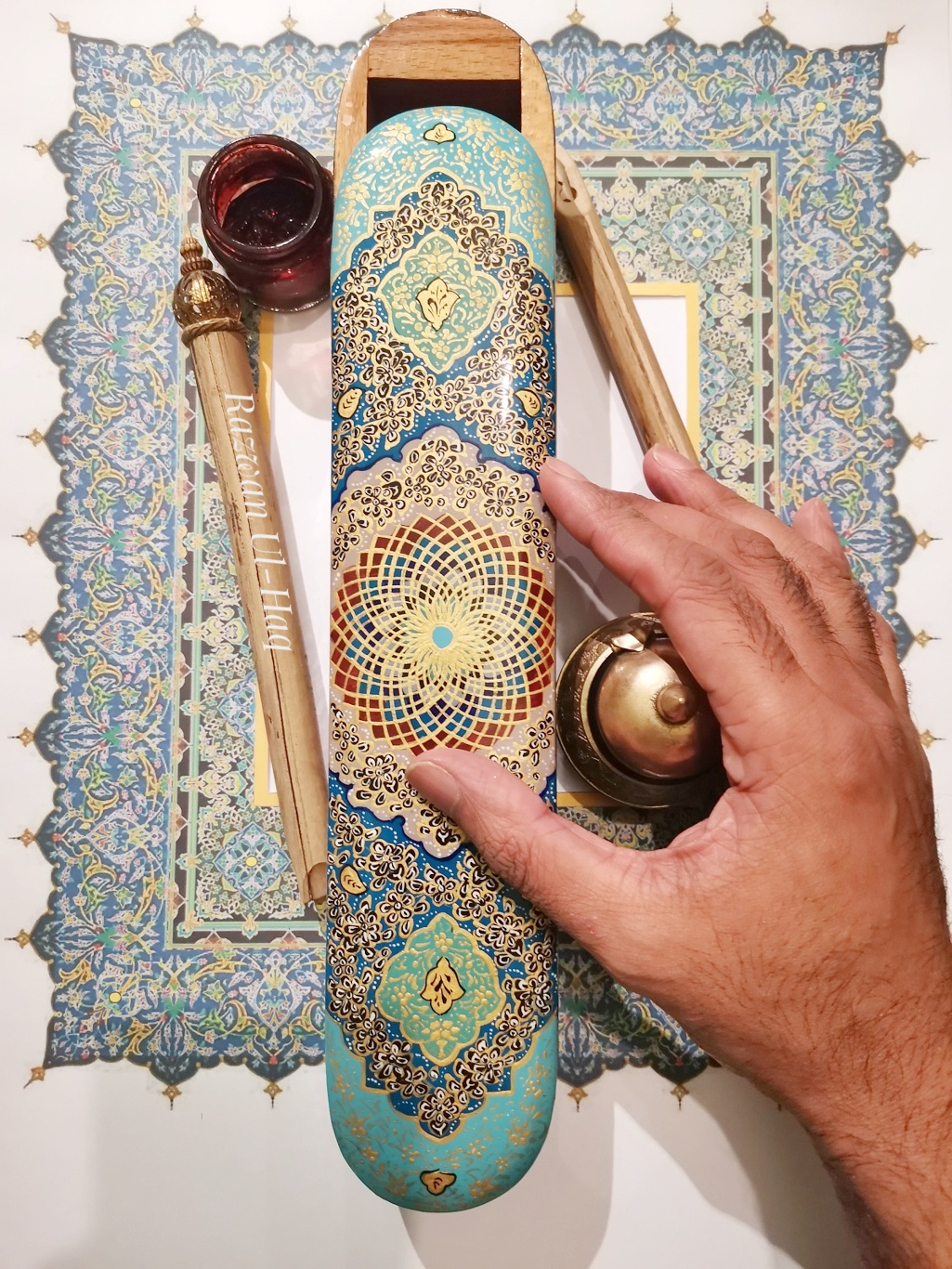 Image of a hand holding calligraphy art materials
