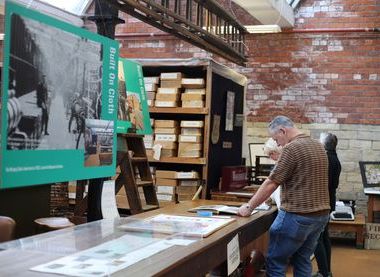 Man looking at images on a wooden table